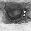 Excavation photograph.  F13, pot exposed from east.
