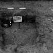 Excavation photograph.  F115 as found, previously partly excavated, from north-east.