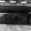 Excavation photograph : area K - detail of drain in slate floor of ventilation slot.