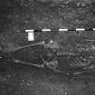 Excavation photograph : area M - skeleton 1100 in coal yard, part cleaned, modern nails indicate position of coffin nails.