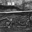 Excavation photograph : area M - detail of skeleton 1122 with head/pillow stone.