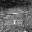 Excavation photograph : area M - skeleton 1159 minus skull, grave at feet cuts ditch 1125, and with 1157 showing in section.