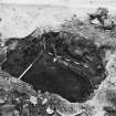 Excavation photograph : area T - S trial hole under Blacksmith's shop with patchy mortar surface overlying bedrock.