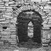 View of W arch of nave and triangular headed W door.