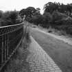 View from NE of the canal and tow-path, with iron railings (foreground left)