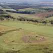 Oblique aerial view centred on the remains of Cairnpapple henge and cairn.
