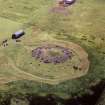 Oblique aerial view centred on the remains of Cairnpapple henge and cairn.
