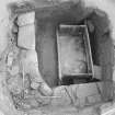 Excavation photographs: Food Vessel Urn in corner of cist; cist after removal of contents.