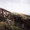View of one of the quarries; Dr Ian Fraser (RCAHMS) in picture