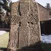 Pictish cross slab in manse garden, view of west (front) face (sunlight)