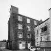 View from N looking into Botany Lane, with four-storeyed mill building (centre).