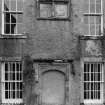 Detail of armorial panels and blocked doorway with inscription