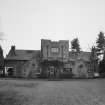 View from North showing entrance front with central service court