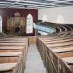 Interior. Gallery  view from S showing curved raked pews