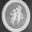 Interior. Entrance hall, detail of oval wall plaque with putti