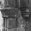 Detail of roundheaded doorway capitals supporting E side of arch.