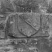 Detail of wall masonry with carved heraldic device.