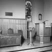 Interior.
View of dais showing pulpit, lectern, table and chairs.
