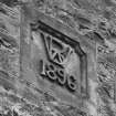 Detail of 1896 plaque bearing the initials "WB" (W.Bonthrone) in E-facing gable of brick-built duty-free warehouse in Bowiehill