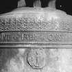 Belfry, bell, detail of inscription band and religious medallion