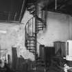 Aberdeen, Spring Garden Iron Works, interior.
General view of cast iron spiral staircase leading to gallery, at West end of half-bay at North-West corner of machine shop.