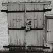 Lochindaal Distillery, Port Charlotte.
Detail of bonded warehouse, specimen strap-hinge door with 'shrouded' hasp-lock.