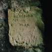 Detail of inscription at entrance to vaulted chamber at N end of range 'repaired in 1819'