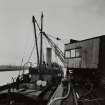 Photographic copy of view showing unloading Raw Materials at factory Wharf