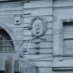 Detail of carved head within wreath on north facade