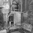 Interior, tower house, Great Hall.
Detail showing fireplace pillow and panelling in South-East corner of Great Hall on first floor.