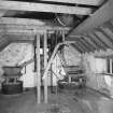 Interior.
View at upper level of mill, showing two pairs of millstones.