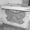 South doorway porch, carved panel (depicting a grotesque), below seat, detail