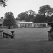 Conservatory and main house, distant view from formal garden steps