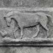 E courtyard range, arched opening, sculpted panel depicting horse and chicken, detail