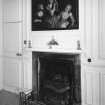 Interior.
East wing first floor bedroom, detail of fireplace and overmantle painting of three girls and a doll.