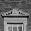 Detail of first floor window pediment on S frontage.