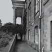 View of S basement area from E showing arched passage under portico