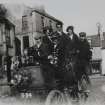 View of group of people in motorcar, Duns. The same group appear in photographs of Dr Welsh's House, Haddington.