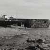 View of landing stage and slate-built harbour wall from N