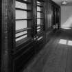 Interior. 
First floor North corridor, detail of bookshelves constructed from woodwork from SS Columbia in 1934.
