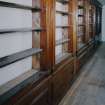 Interior. 
First floor West corridor, detail of bookshelves constructed from woodwork from SS Columbia in 1934.
