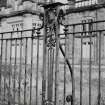 Detail of decorative iron work on railings outside main frontage.