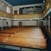 Interior. View of interior from E showing pews and galleries