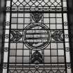 Interior. Detail of stained glass window with texr