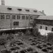 View of tannery's yard and tanning pits from W.
