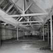 Interior view from W within single-storeyed (possibly weaving) shed to rear of high mill.