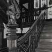 Interior. View of stair hall from SSE with lamp bearing dragon newel