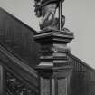 Interior. Detail of staircase lamp bearing dragon newel post