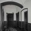 Interior. Detail of panelling and doors in stair hall