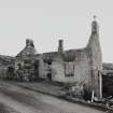 View from SW of dilapidated building with three bays.